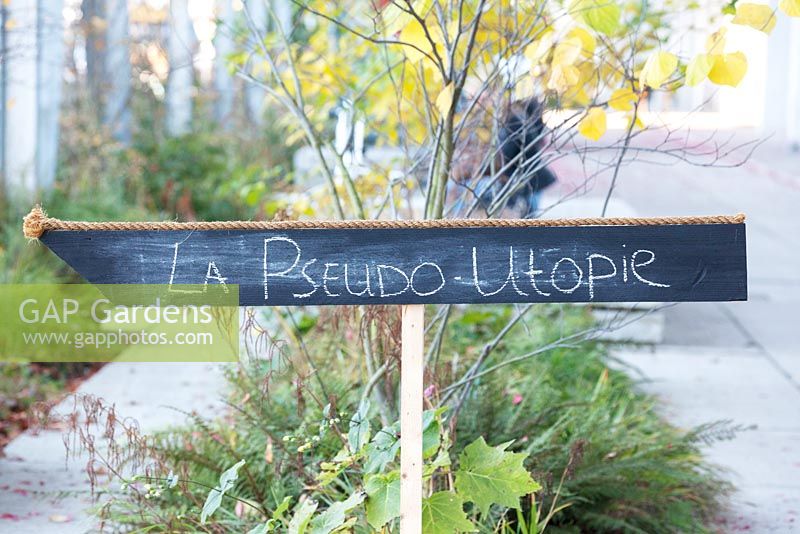 Signboard with crayons written text La pseudo Utopie.