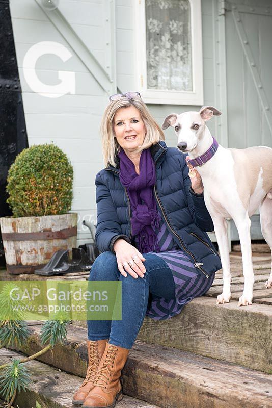 Annie Stanford with three year old whippet Flynn on the platform of the railway carriage