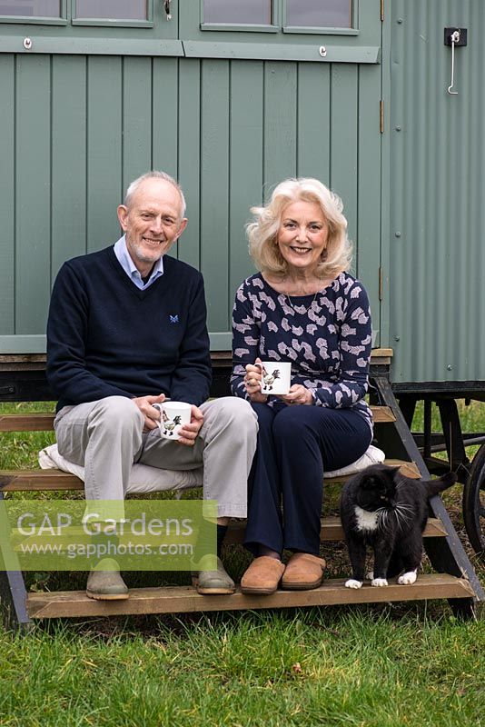 Doug and Sue Copeland on the steps of their Shepherd's Hut.