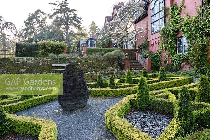 Slate garden with box parterre surrounding a slate sculpture. Hergest Croft Gardens, Kington, Herefordshire