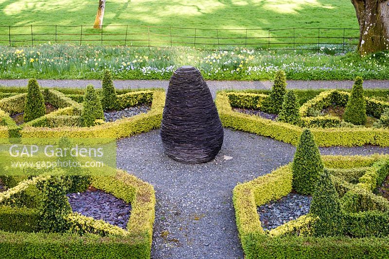 Slate garden with box parterre surrounding a slate sculpture. Hergest Croft Gardens, Kington, Herefordshire