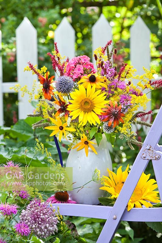 Summer perennials and annuals arrangement.  Rudbeckia hirta, Echinacea purpurea, Agastache 'Black adder', Persicaria 'Firetail', Monarda, Achillea filipendulina 'Gold Plate', Galium verum, Lythrum salicaria, Sanguisorba officinalis, mint, sunflower, Phlox.