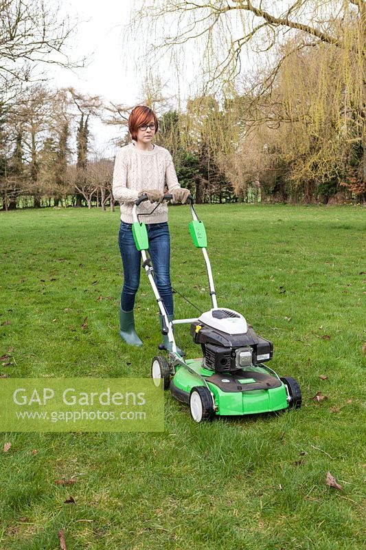 Lady using rotary grass cutter
