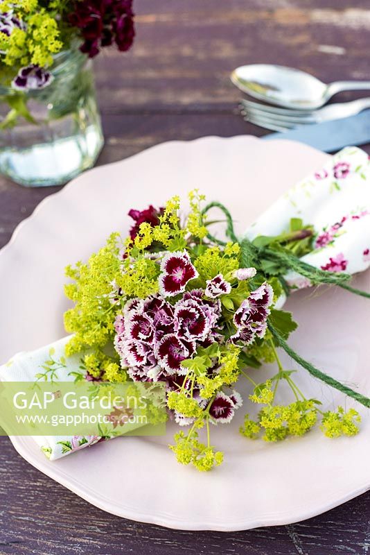 Summer table place setting with Dianthus barbartus - Sweet Williams and alchemilla mollis