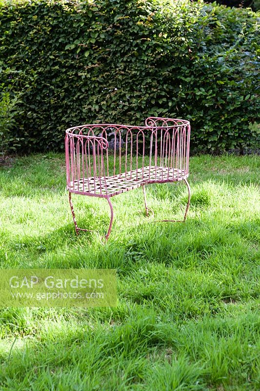 Metal seat in the Orchard. Hill House, Glascoed, Monmouthshire, Wales. 