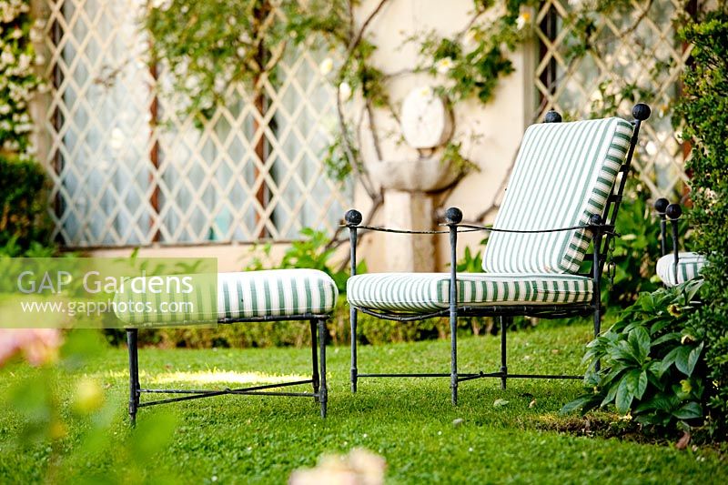 Seating area on lawn. La Limonaia Garden. Designed by Arabella Lennox Boyd. Fiesole. Florence. Italy