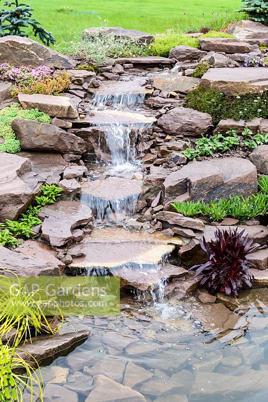 Waterfall. Naturalistic Water Garden - Jackie Knight's Just Add Water - RHS Chatsworth Flower Show 2017  Designer: Jackie Sutton - Built and sponsored by Jackie Knight Landscapes