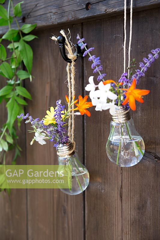 Home made hanging vase made from a lightbulb - hang two or more vases together for a pretty display