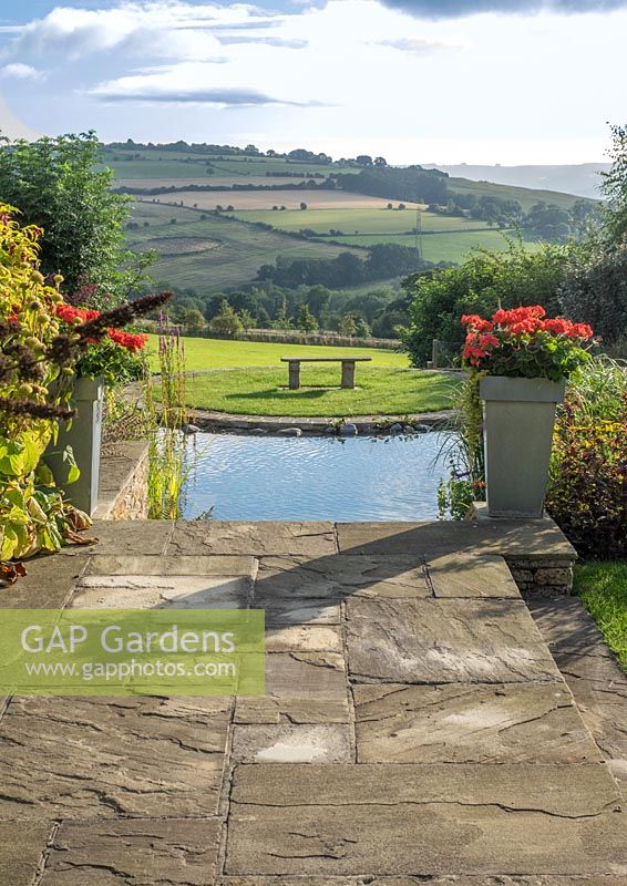 Looking down from the terrace towards the pool and then onto the rolling hills of the Cotswold countryside.