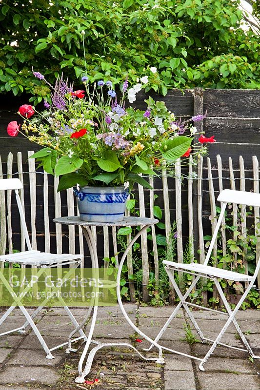 Floral display of early summer flowers on the table. Hetty van Baalen garden, The Netherlands