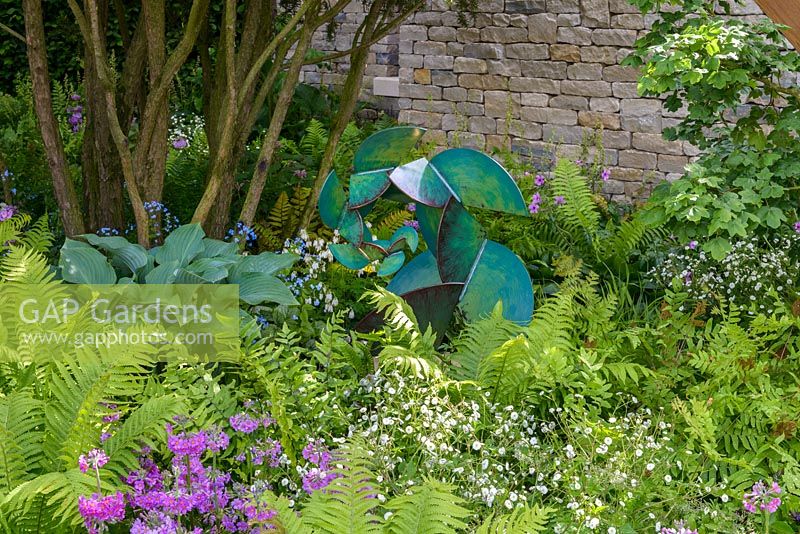 Garden Goddess Sculpture by Craig Schaffer with woodland planting of ferns, Hostas and Primula beesiana in The Morgan Stanley Garden - RHS Chelsea Flower Show 2017 - Designer: Chris Beardshow - Sponsor: Morgan Stanley. Peoples Choice Award Winner