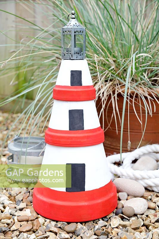 Making a Garden Lighthouse Lantern with Terracotta Pots - add a small lantern or jam jar on to the top with a tealight