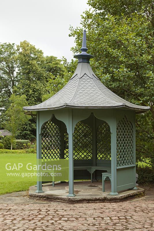 Aqua painted gazebo on lawn with trees - June, Cheshire