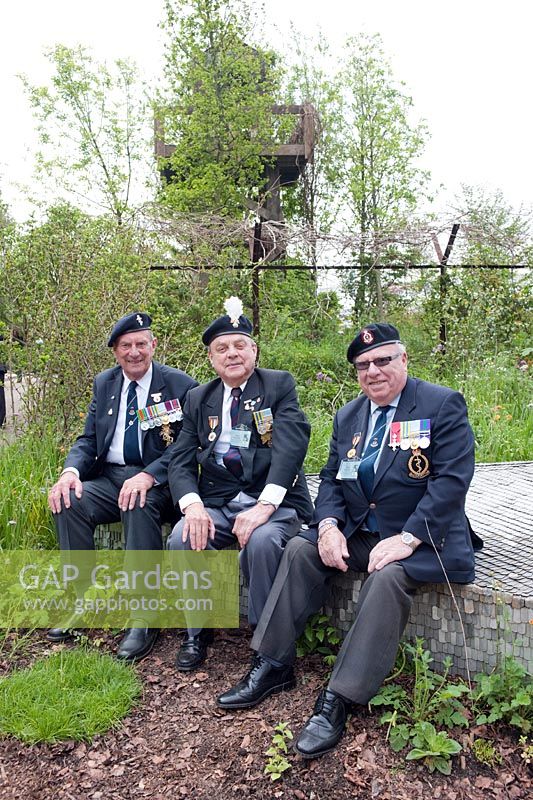 Ex-British soldiers with medals from the Korean War sitting in 'Quite Time', DMZ Forbidden Garden, RHS Chelsea, 2012.