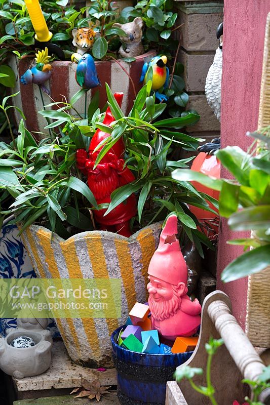 Garden gnomes and retro concrete pots with toy birds, June.