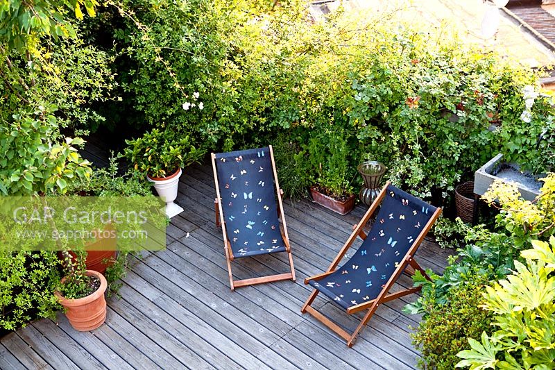 Deckchairs on terrace, Milan, Italy, May.