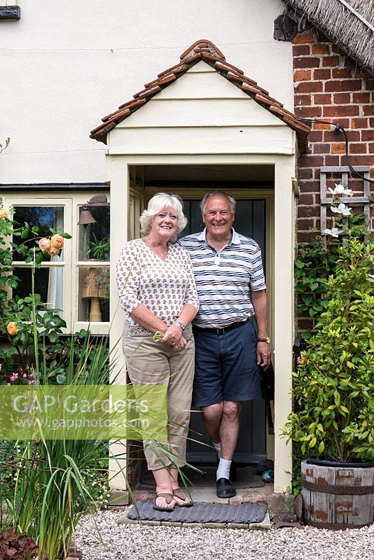 Les and Lynn Mann standing in the doorway of their seventeenth century cottage.