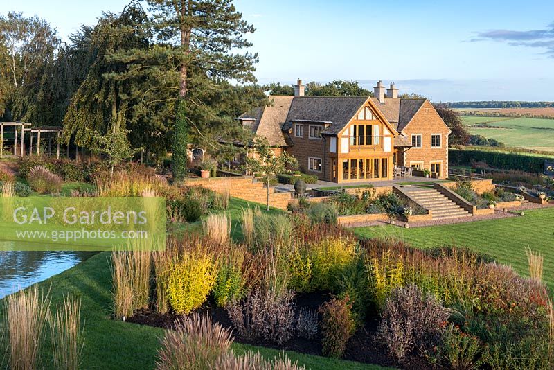 Prairie style beds, with modern Arts and Crafts style house set against a backdrop of the Welland Valley.