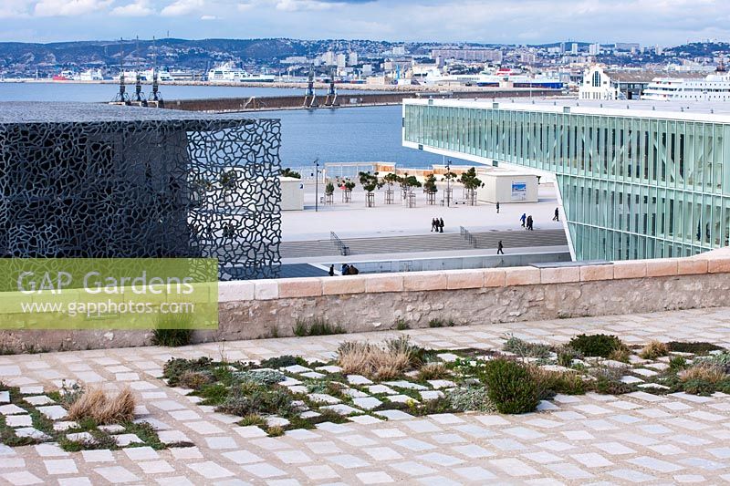 Planted stone slabs and view from the Jardin de Migrations, Saint Jean, Marseilles, France, February.