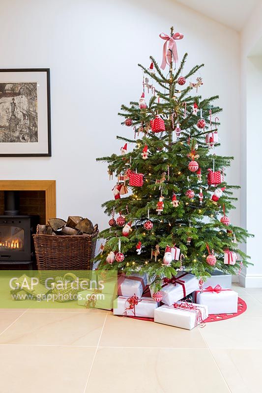 Red and white colour themed Christmas tree in living room