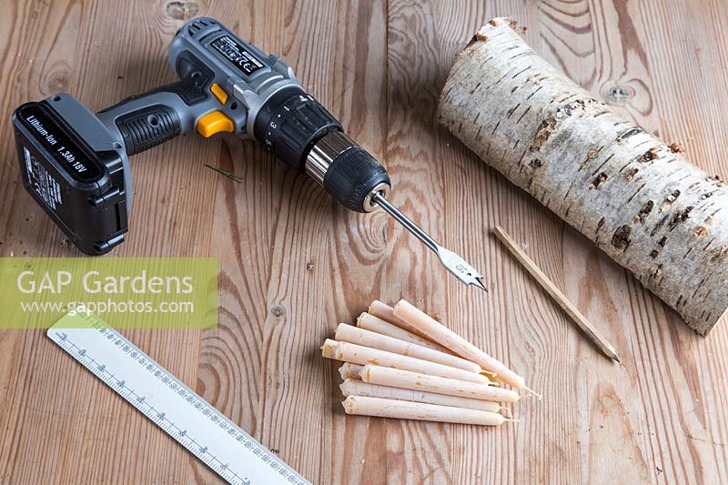 Equipment and materials required to make Birch candle holder. Including cordless drill, ruler, pencil, beeswax candles and sawn birch wood.