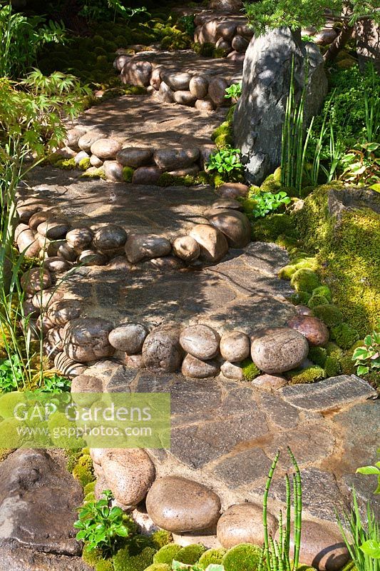 Stone and pebble path with shallow steps in a Japanese style garden