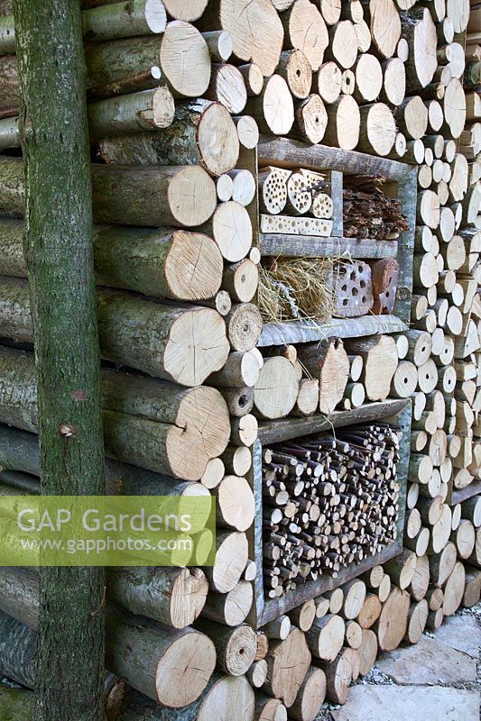 Insect hotel set in a log wall