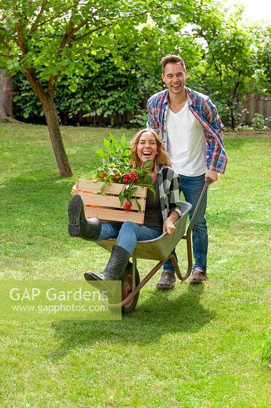 Young couple with wheel barrow