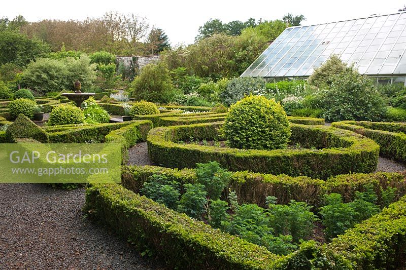 Pond, fountain, box hedges and topiary in the Elizabethen Knot Garden at Dalemain House & Garden, Cumbria