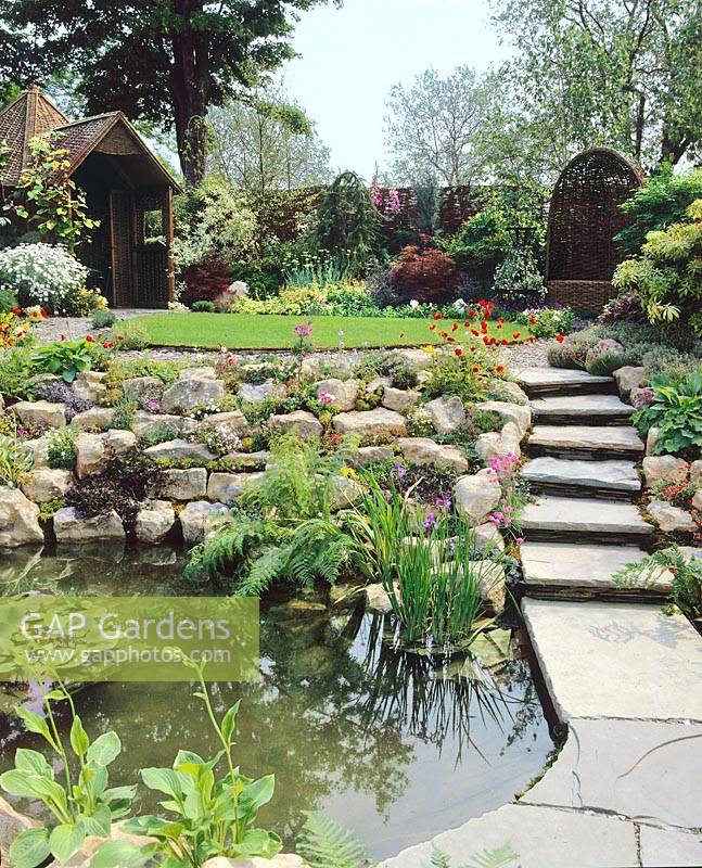 Rock garden with perennials and pond