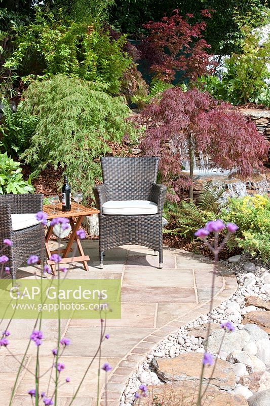 Natural stone terrace with wicker garden furniture