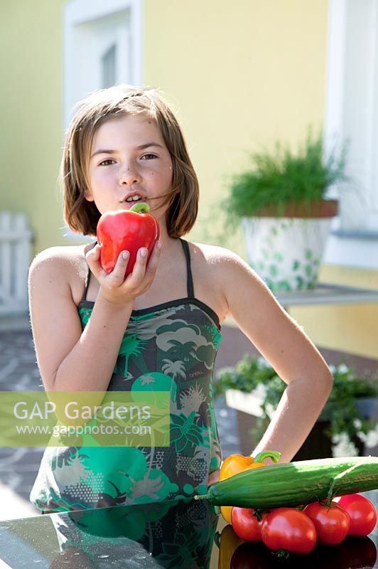 Girl with red bell pepper