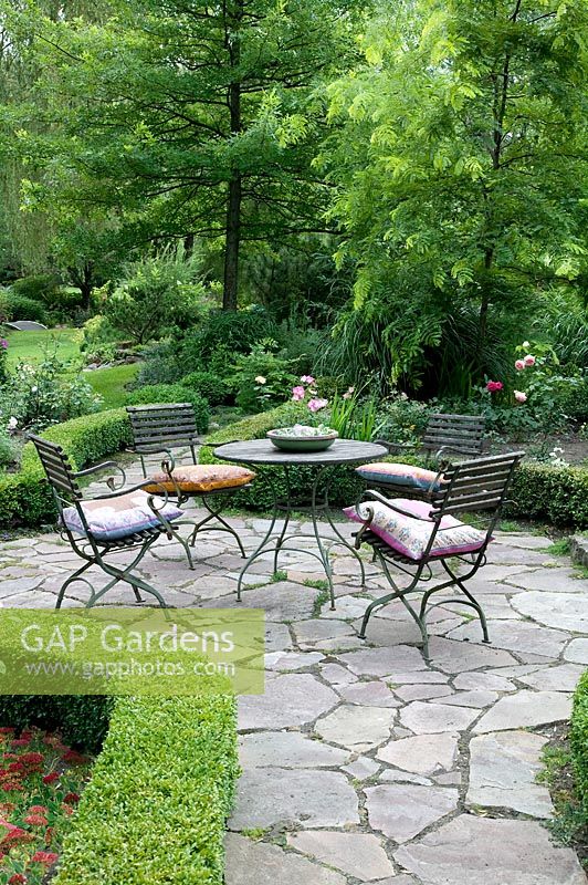 Iron garden furniture on a stone terrace 