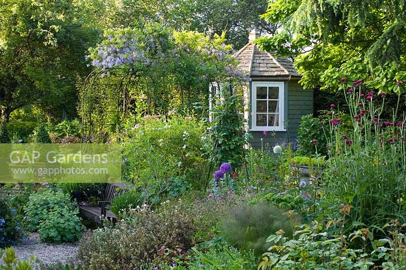 Bullock Horn Cottage, Wilts, UK ( des. Liz Legge ) small, contemporary cottage garden in early summer, summerhouse and pergola