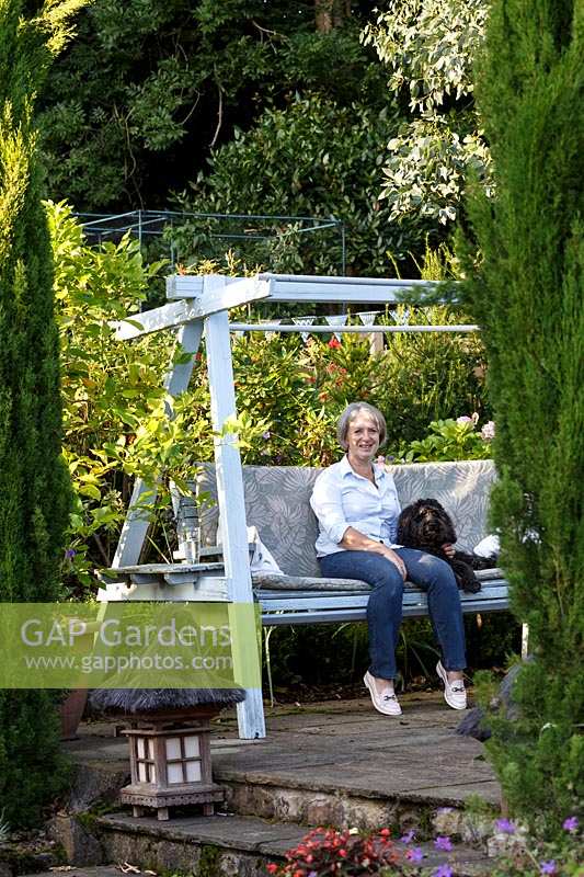 Jackie Healy's garden near Chepstow. Early autumn garden.  The swing bench
