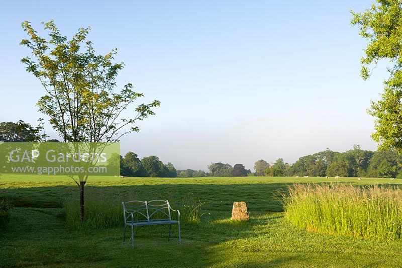 Wellfield Barn, Wells, Somerset, UK ( Nasmyth ) elegant metal bench and view across farmland,( PR available )