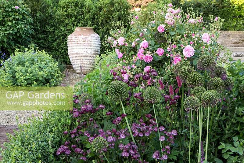 Informal purple and pink border with eye catching urn