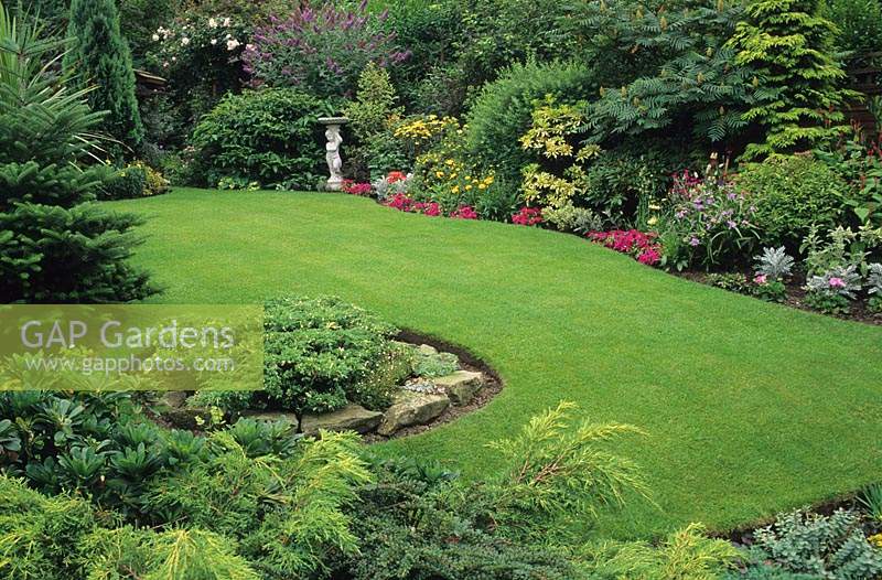 Private garden Wolverhampton Lawn gently sloping site colourful summer flowering annuals conifers