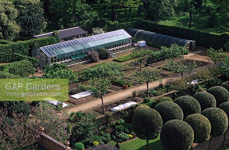 Hatfield House. Hertfordshire. Organic walled kitchen vegetable garden over view. glass houses.