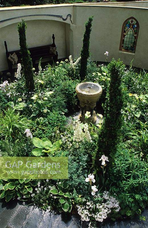 Chelsea 1998 Design Fiona Lawrenson Overview of circular white garden with water feature as focal point and Buxus Greenpeace