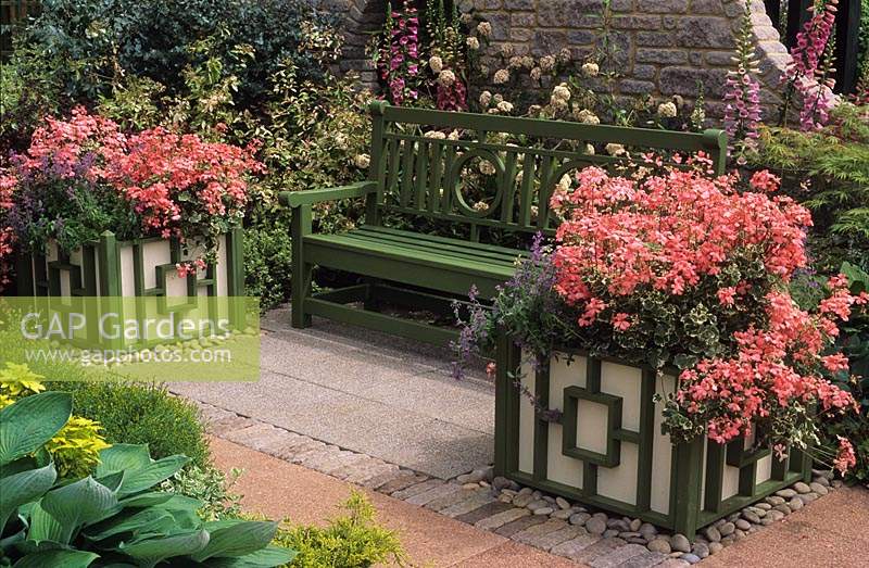 Chelsea FS 1991 Green wooden bench with pink Pelargoniums in Versailles tubs