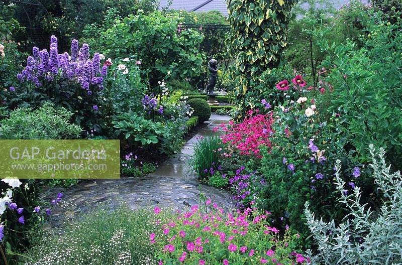 The Dillon Garden Dublin Ireland the blue cool colour borders stone path and statue as focal point