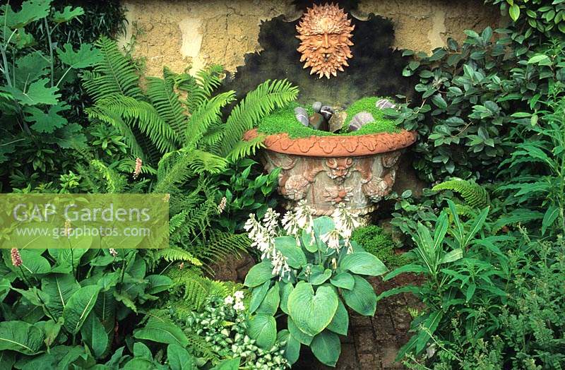 private garden Warwickshire large Whichford pot water feature with wall mounted fountain in small shady courtyard garden