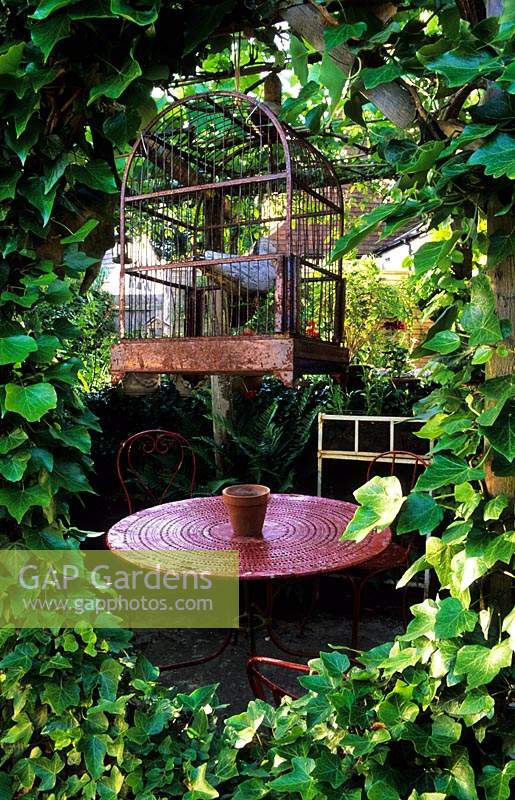 Park Terrace Sussex covered sheltered seating area with table and chairs and decorative vintage birdcage
