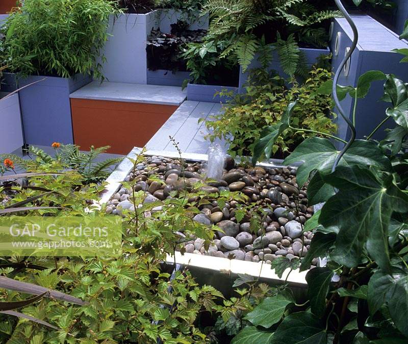 Chelsea FS 2002 design Nathalie Charles colourful contemporary roof garden with formal stainless steel pebble water feature