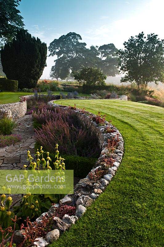 contemporary sunken garden stone walls retaining designer design Julie Toll curved circular sinuous patio summer perennials tree