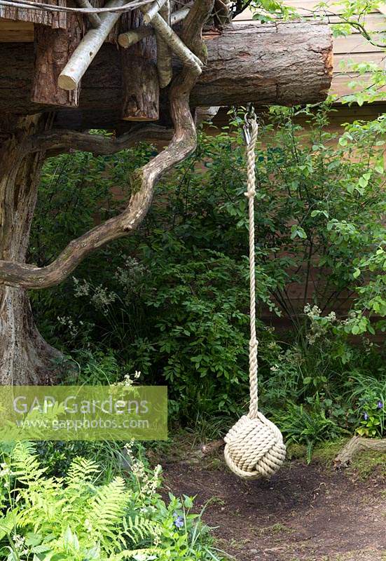 The RHS Back to Nature Garden  – rope swing for children hanging from tree branch, ferns - Designer: HRH The Duchess of Cambridge with Andree Davies and Adam White - Sponsor: The RHS 