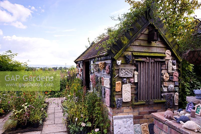 Shed with plaster plaques at Hilltop garden, July