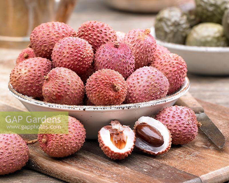 Litchi chinensis - lychee, cut open to show white flesh and stone