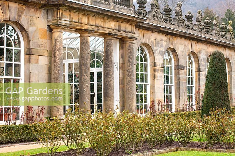 Historic glasshouse or orangery with architectural features
 